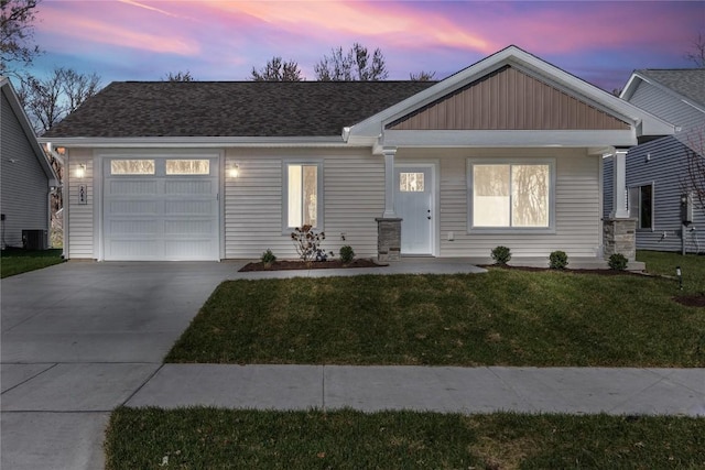 view of front of property with a garage and a lawn