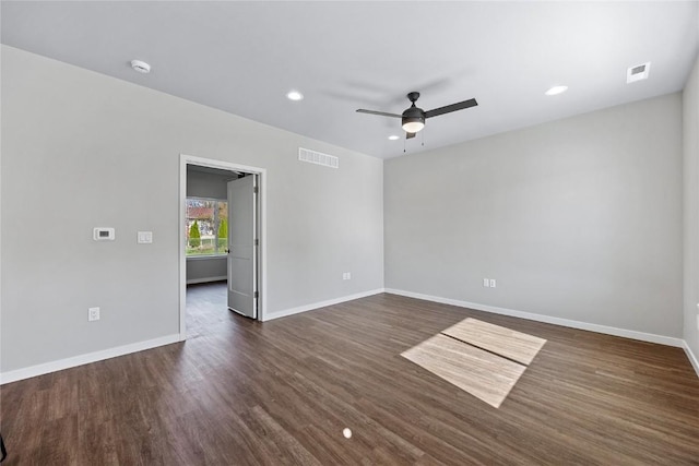 empty room with ceiling fan and dark hardwood / wood-style floors