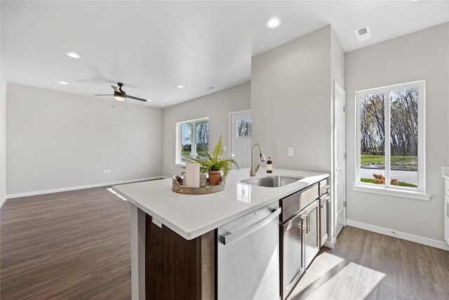 kitchen with dishwasher, plenty of natural light, wood-type flooring, and sink