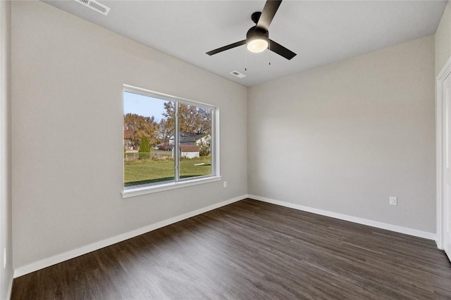 unfurnished room featuring ceiling fan, a healthy amount of sunlight, and dark hardwood / wood-style floors