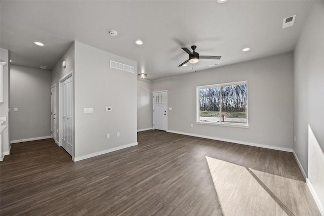 unfurnished room featuring ceiling fan and dark hardwood / wood-style flooring