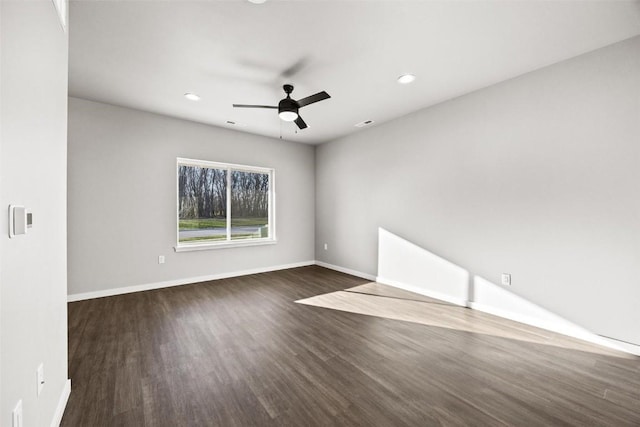 unfurnished room featuring ceiling fan and dark hardwood / wood-style flooring