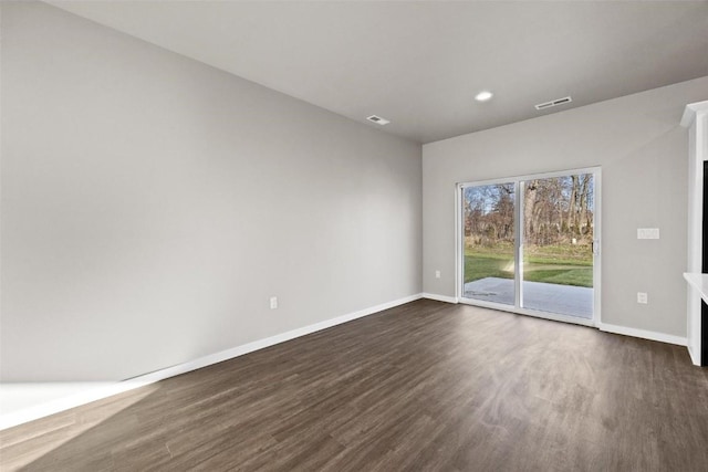 empty room with dark hardwood / wood-style flooring