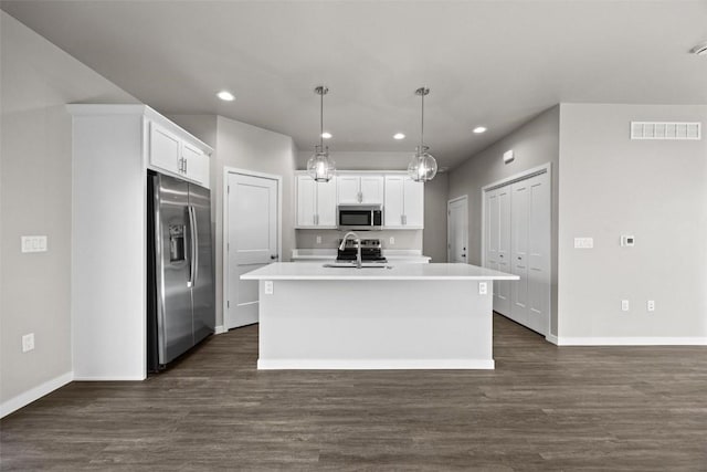 kitchen featuring appliances with stainless steel finishes, sink, pendant lighting, a center island with sink, and white cabinets