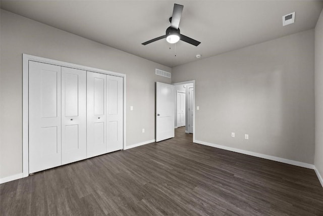 unfurnished bedroom featuring a closet, ceiling fan, and dark hardwood / wood-style flooring