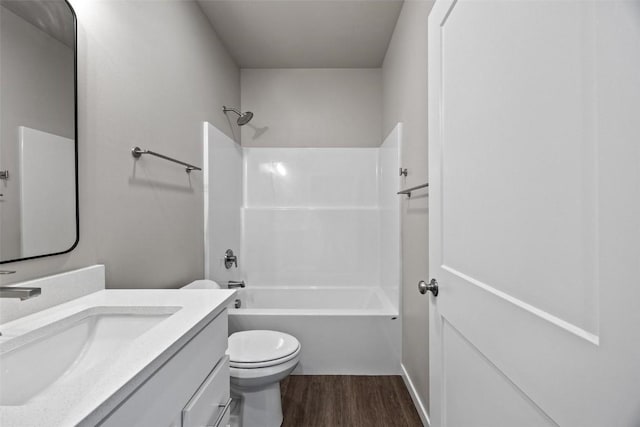 full bathroom featuring hardwood / wood-style floors, vanity, toilet, and tub / shower combination