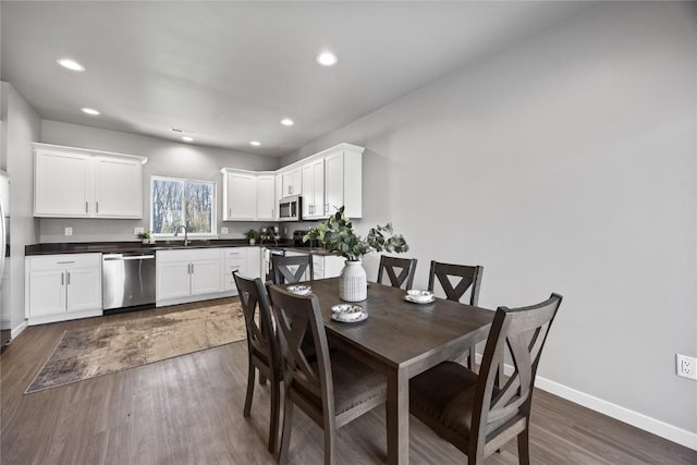 dining space featuring dark hardwood / wood-style floors and sink