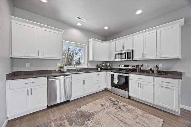 kitchen with sink, white cabinetry, and stainless steel appliances