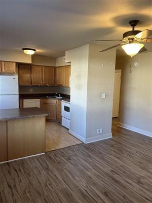 kitchen featuring ceiling fan, dark hardwood / wood-style floors, and white appliances