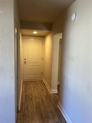 hallway with dark hardwood / wood-style floors