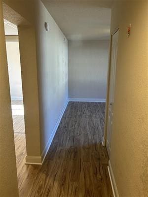 corridor featuring dark hardwood / wood-style flooring