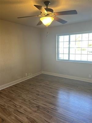 unfurnished room with dark wood-type flooring