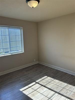 unfurnished room featuring dark hardwood / wood-style floors