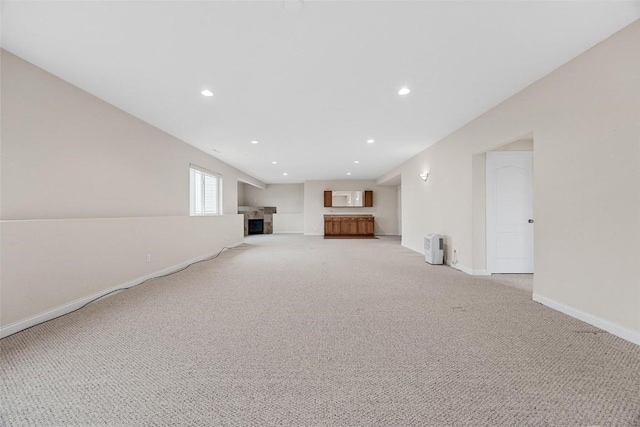 basement featuring light carpet