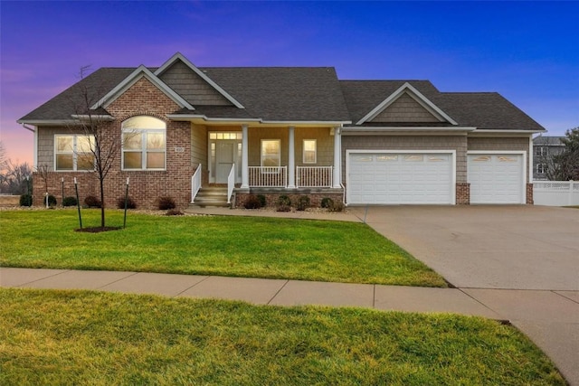 craftsman-style home featuring a lawn, a porch, and a garage