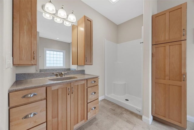 bathroom with vanity and a shower