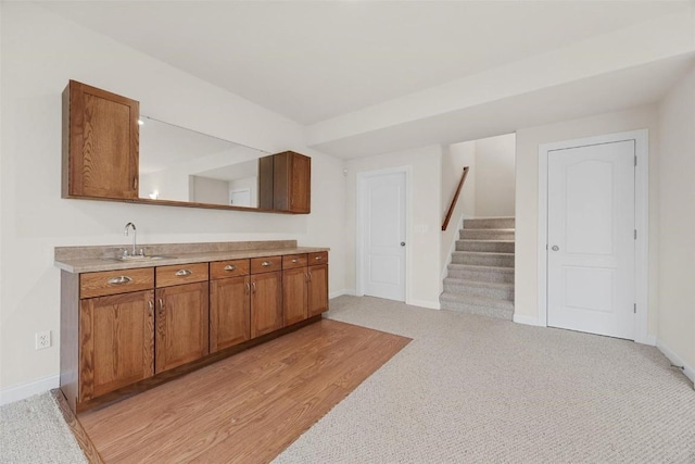 kitchen featuring sink and light colored carpet