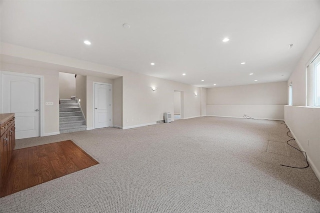 unfurnished living room featuring light carpet