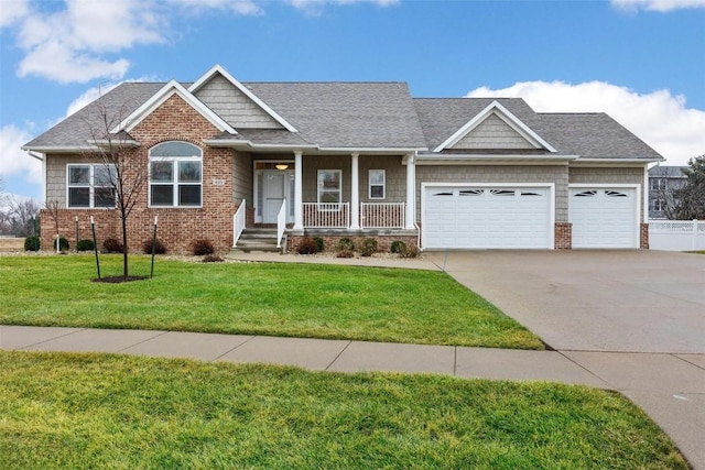 view of front of house with a front yard, a porch, and a garage