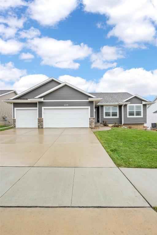 single story home featuring a front yard and a garage