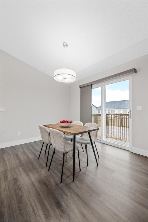 dining space with dark hardwood / wood-style floors