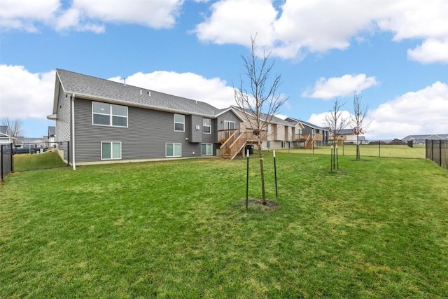 rear view of house with a lawn