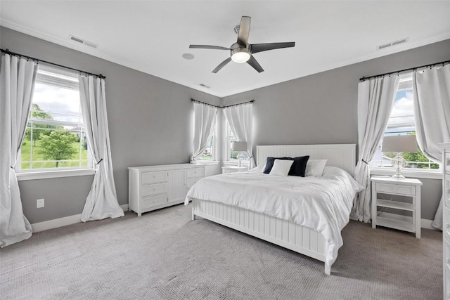 bedroom with ceiling fan and light carpet