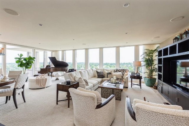 living room featuring light colored carpet and a wall of windows