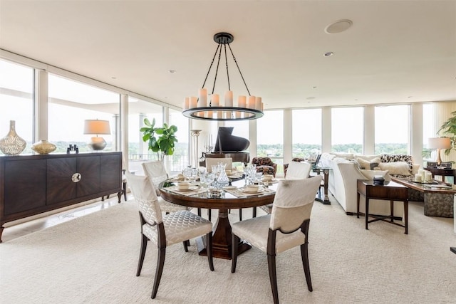 dining space with floor to ceiling windows and a notable chandelier