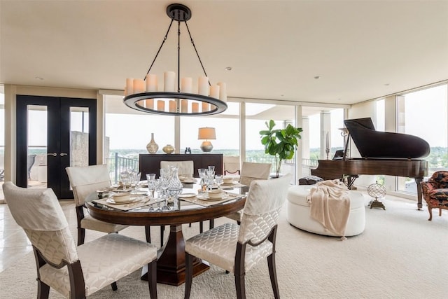 dining area with a chandelier, french doors, a wall of windows, and plenty of natural light