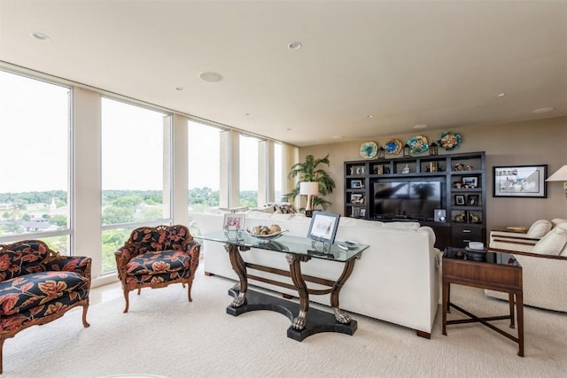 living room featuring light carpet and floor to ceiling windows