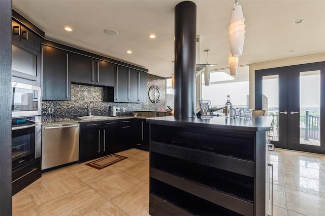 kitchen with french doors, backsplash, stainless steel appliances, sink, and light tile patterned flooring