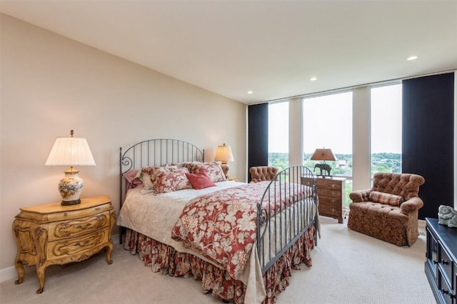 bedroom with carpet flooring and a wall of windows