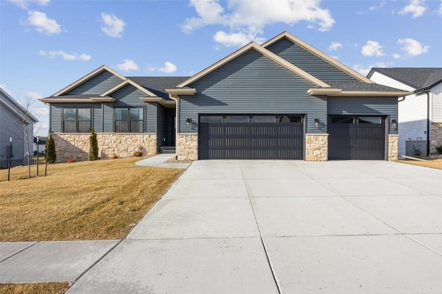 craftsman house with a front yard and a garage