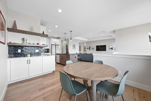 dining area featuring sink and light hardwood / wood-style floors