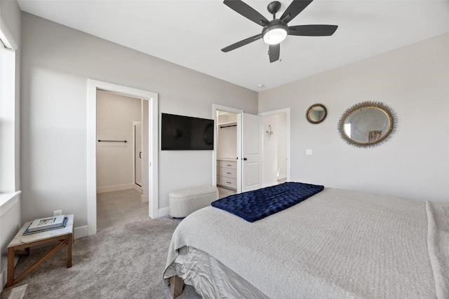 bedroom featuring ceiling fan, a spacious closet, light carpet, and a closet