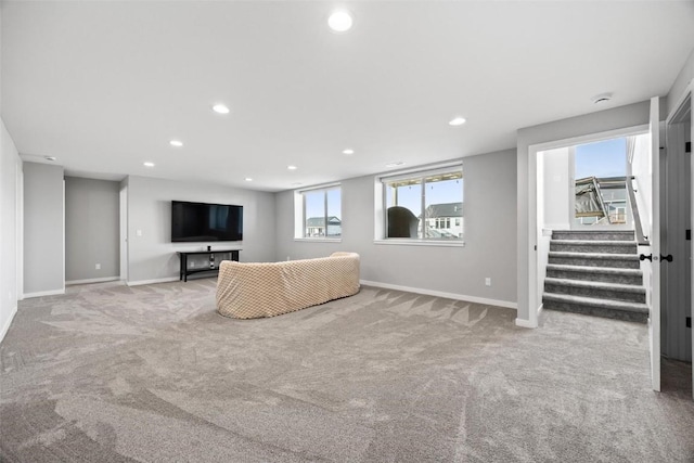 unfurnished living room featuring light carpet