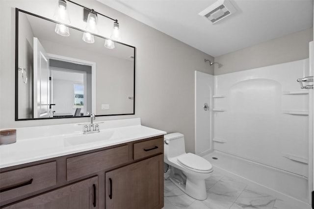 bathroom with a shower, vanity, and toilet