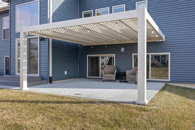 back of house featuring a lawn, a patio area, and a pergola