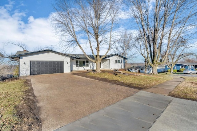 ranch-style house with a front yard and a garage