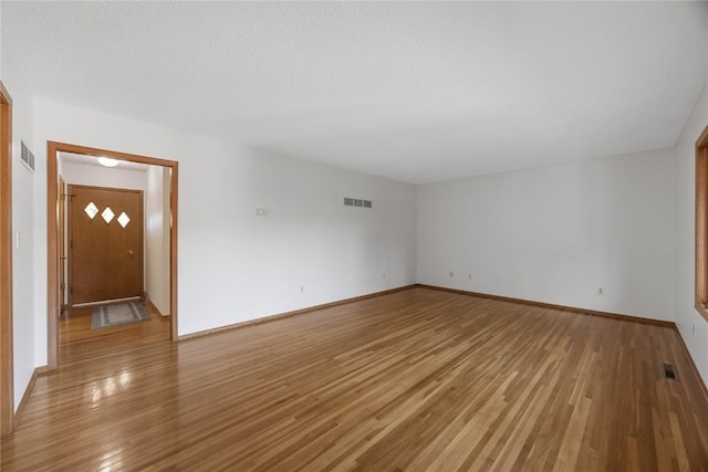 spare room featuring light hardwood / wood-style floors