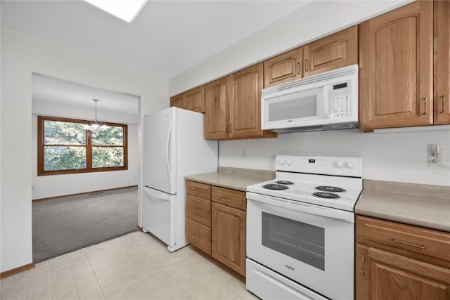 kitchen with hanging light fixtures, light colored carpet, a chandelier, and white appliances