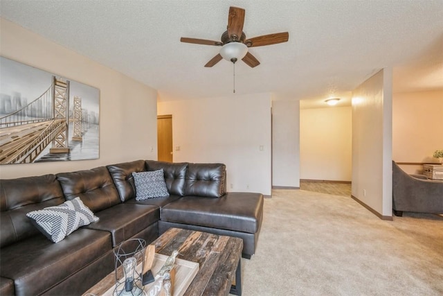 carpeted living room with a textured ceiling and ceiling fan