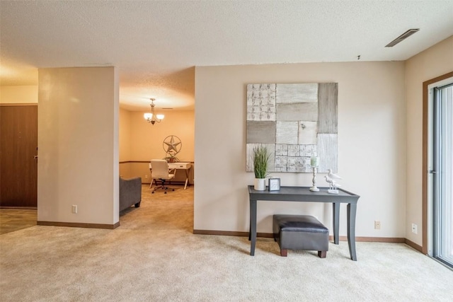 interior space featuring carpet flooring, a textured ceiling, and an inviting chandelier