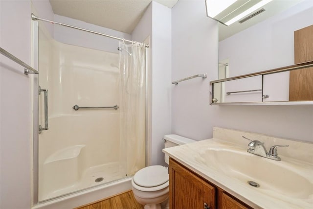 bathroom with a shower with shower curtain, vanity, toilet, and hardwood / wood-style floors