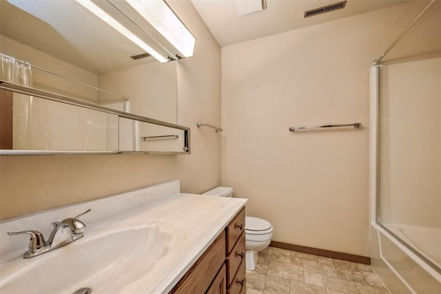 full bathroom with vanity, enclosed tub / shower combo, and toilet