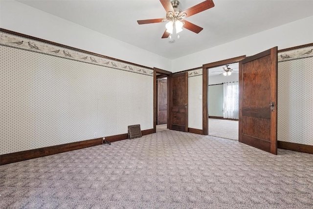 unfurnished bedroom with ceiling fan and carpet floors