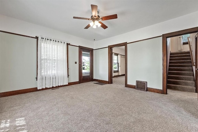 unfurnished living room with ceiling fan and carpet floors