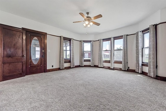 interior space with ceiling fan