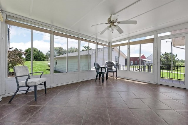 sunroom featuring ceiling fan and plenty of natural light